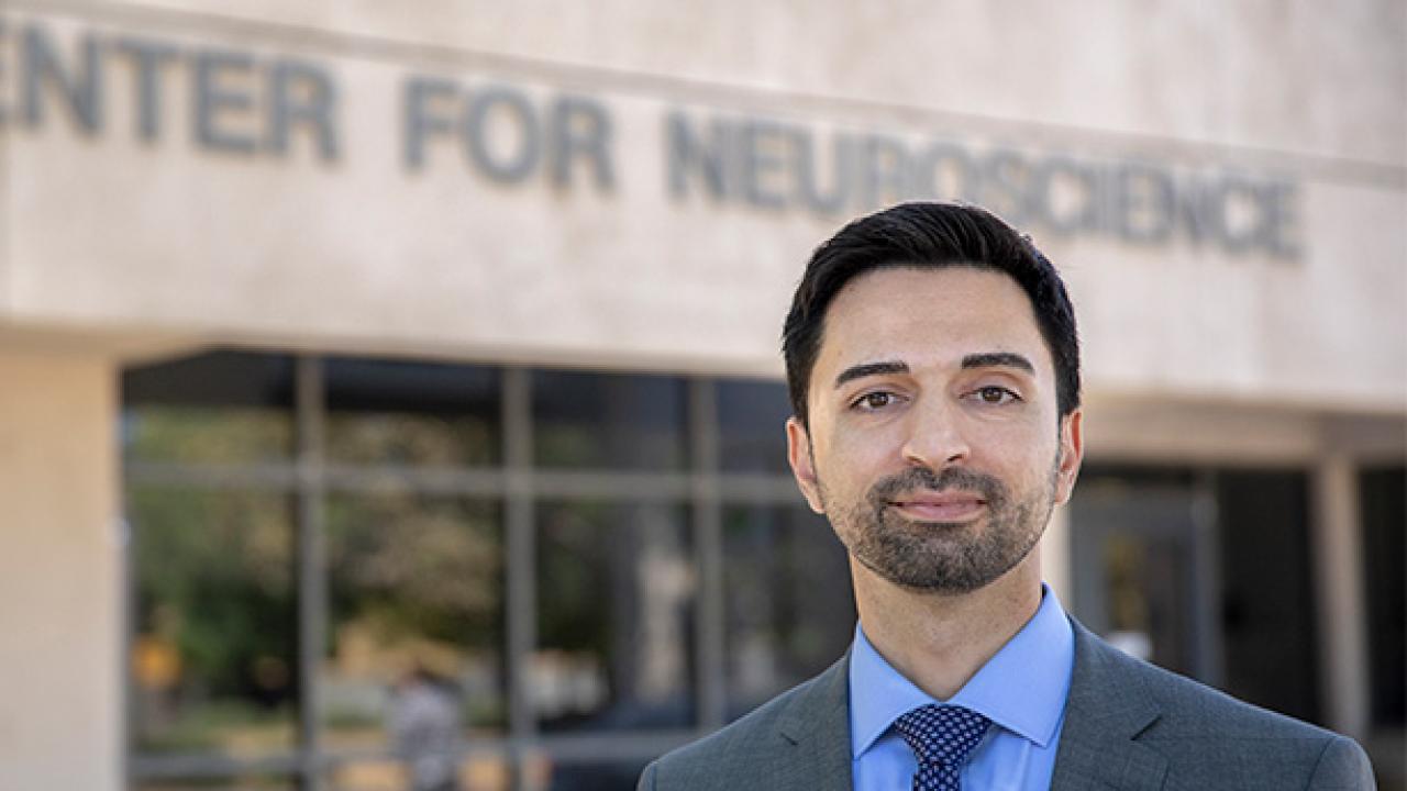 A man standinging in front of the UC Davis Center for Neuroscience building.